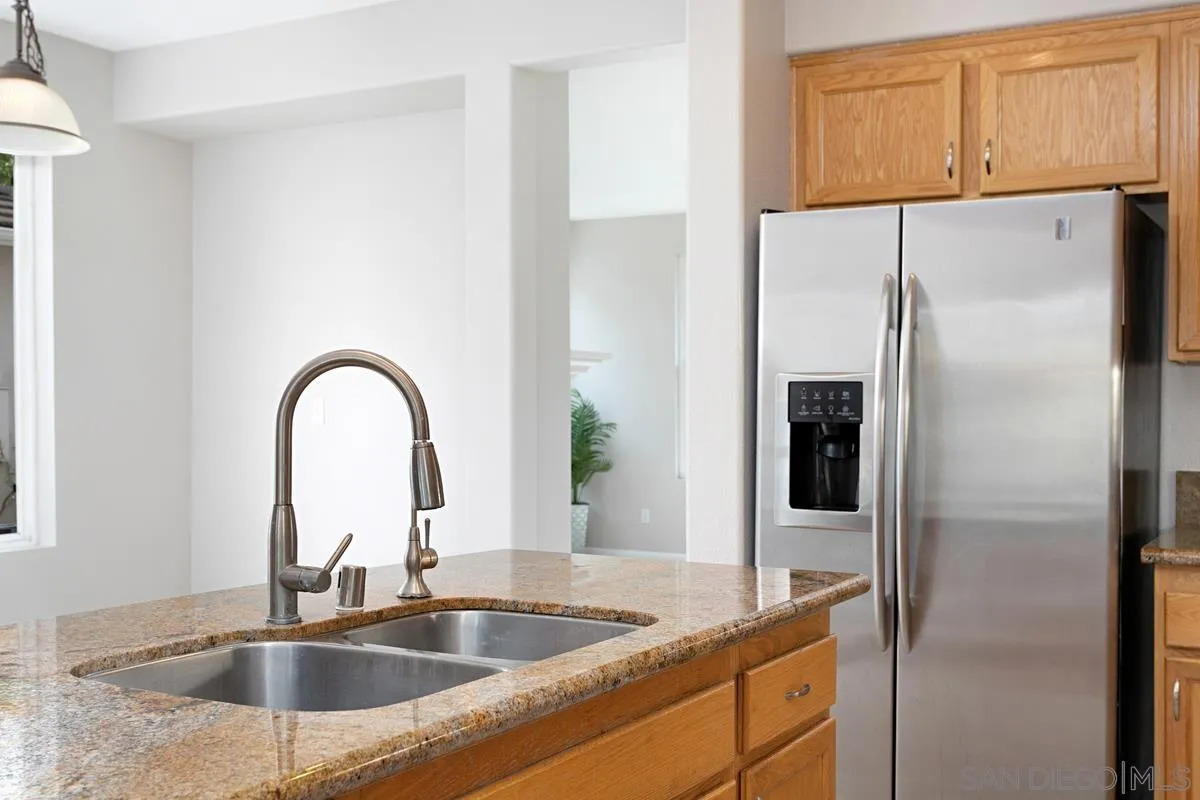 12253 Pepper Tree Lane Poway, CA 92064 - Photo 8 of 39 a kitchen with a refrigerator and a sink