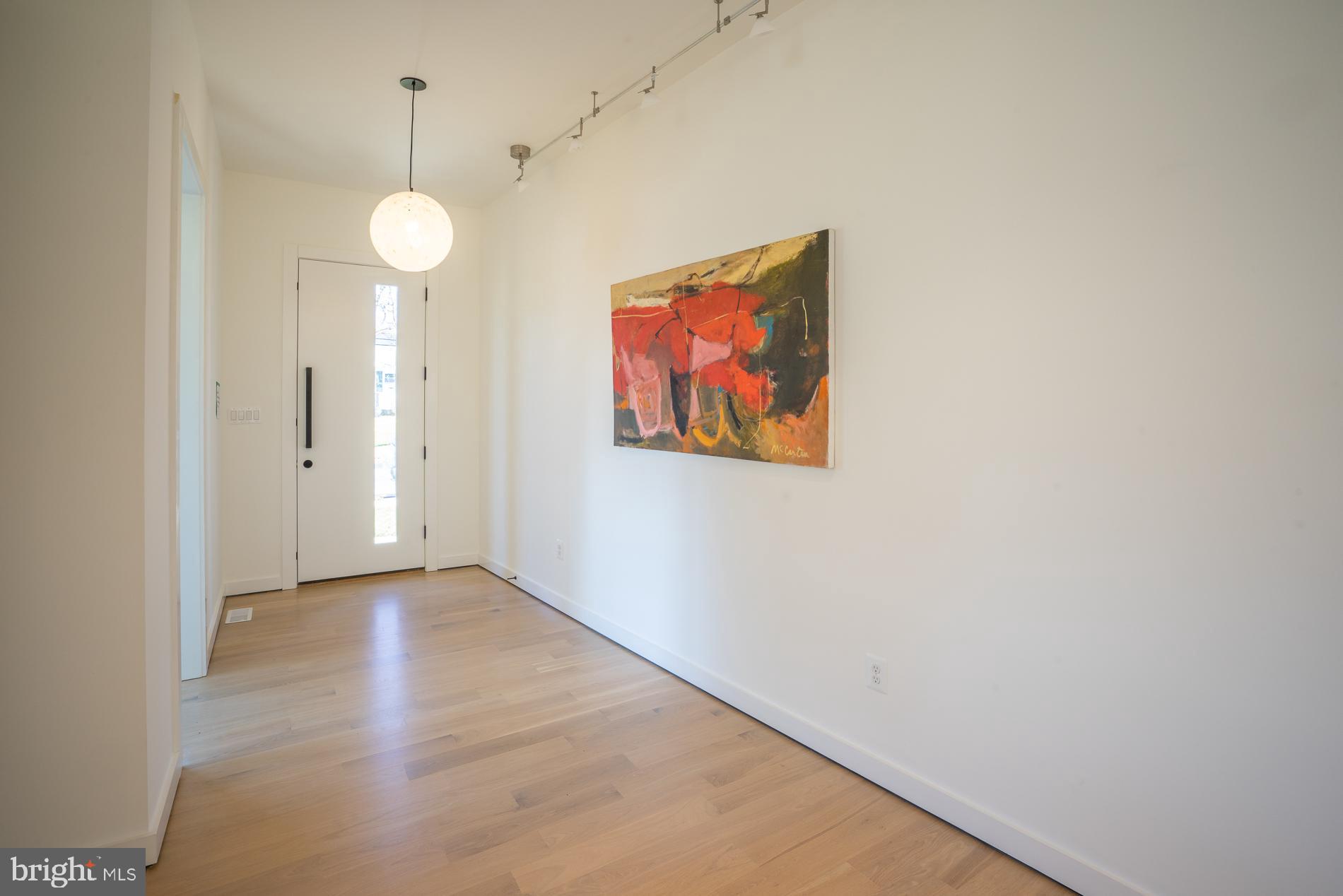 114 Tapawingo Road Southwest Vienna, VA 22180 - Photo 47 of 67 Foyer with art wall and hanging glass pendant