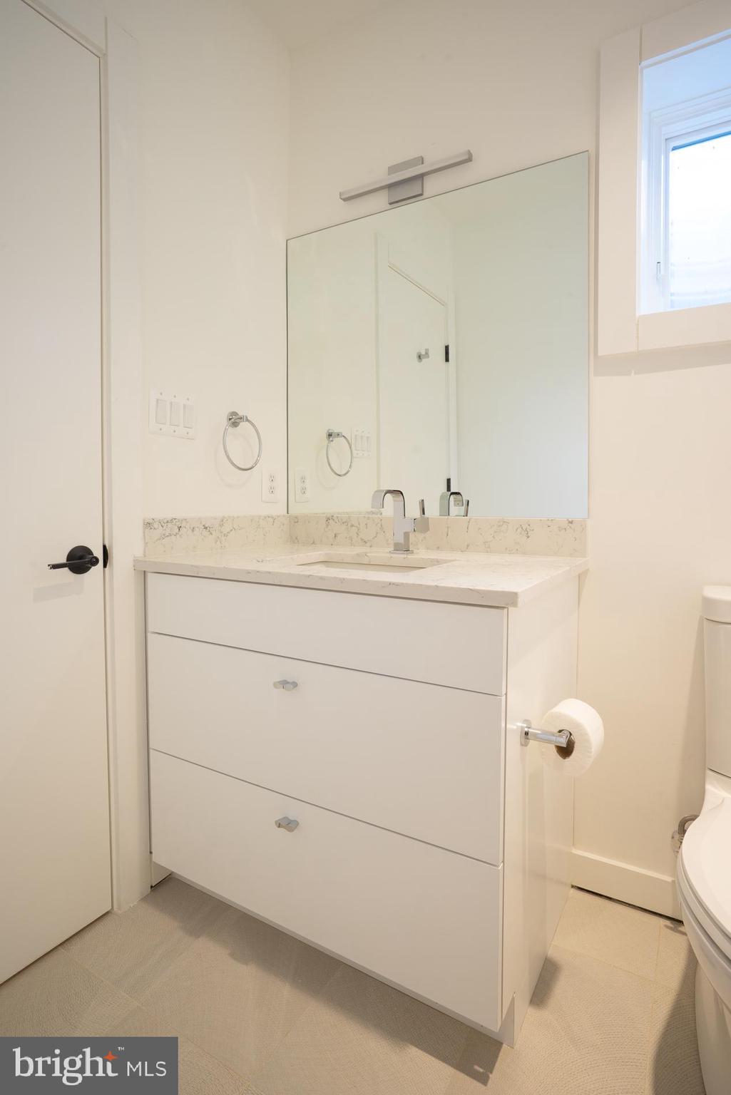 114 Tapawingo Road Southwest Vienna, VA 22180 - Photo 52 of 67 Lower level white vanity, window brings in light