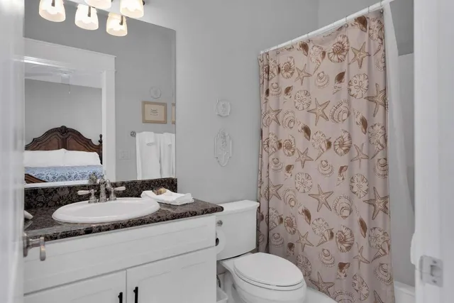 a large kitchen with granite countertop a sink and dishwasher a stove with wooden floor