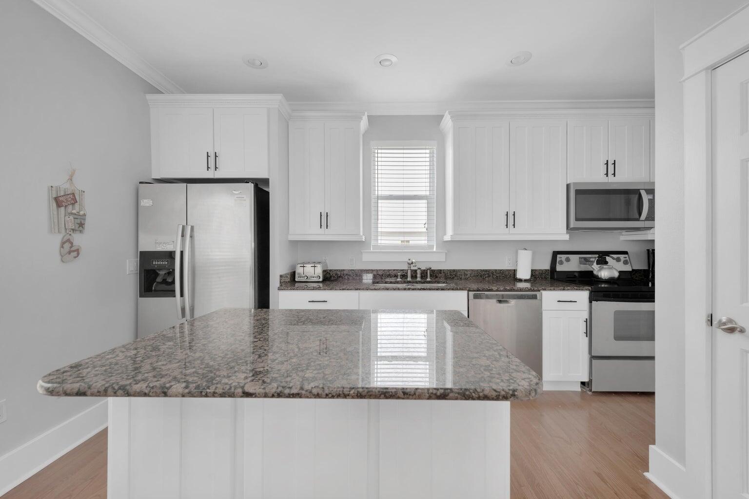 18 Beach Bike Way Inlet Beach, FL 32461 - Photo 68 of 80 a kitchen with stainless steel appliances granite countertop a refrigerator a stove a sink and white cabinets