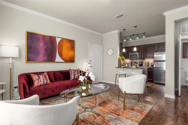 a living room with furniture kitchen view and a table