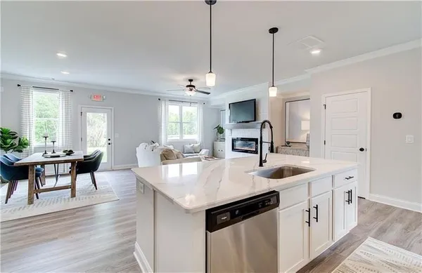 a kitchen with stainless steel appliances granite countertop a sink a stove and a refrigerator