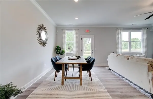 a living room with furniture a window and a table