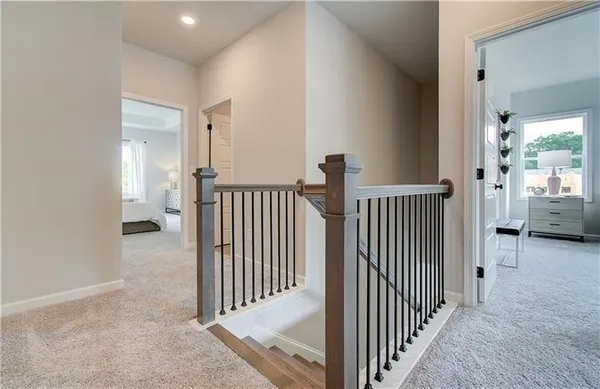 a view of a hallway to a room with stairs