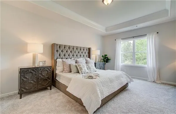 a bedroom with a bed flowerpot and window