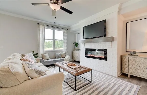 a living room with furniture a flat screen tv and a fireplace
