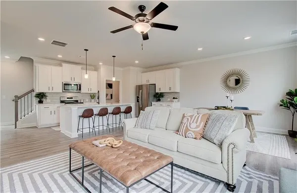 a living room with furniture and kitchen view