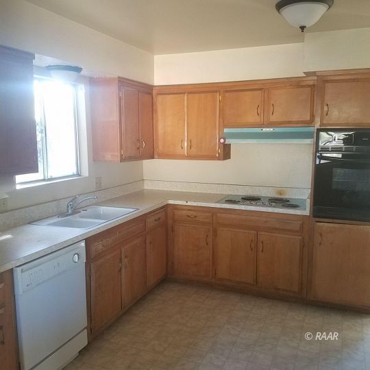 324 West Perdew Avenue Ridgecrest, CA 93555 - Photo 6 of 14 a kitchen with a sink cabinets and window