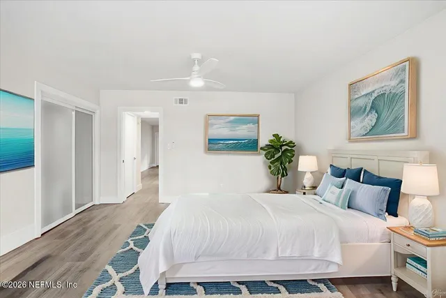 a bedroom with a bed and a painting on the wall