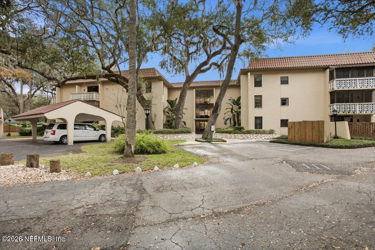 1810 Sevilla Boulevard West, Unit 310 Atlantic Beach, FL 32233 - Photo 2 of 18 a view of a car park in front of a building