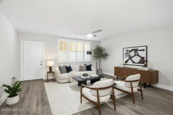 a living room with furniture and a potted plant