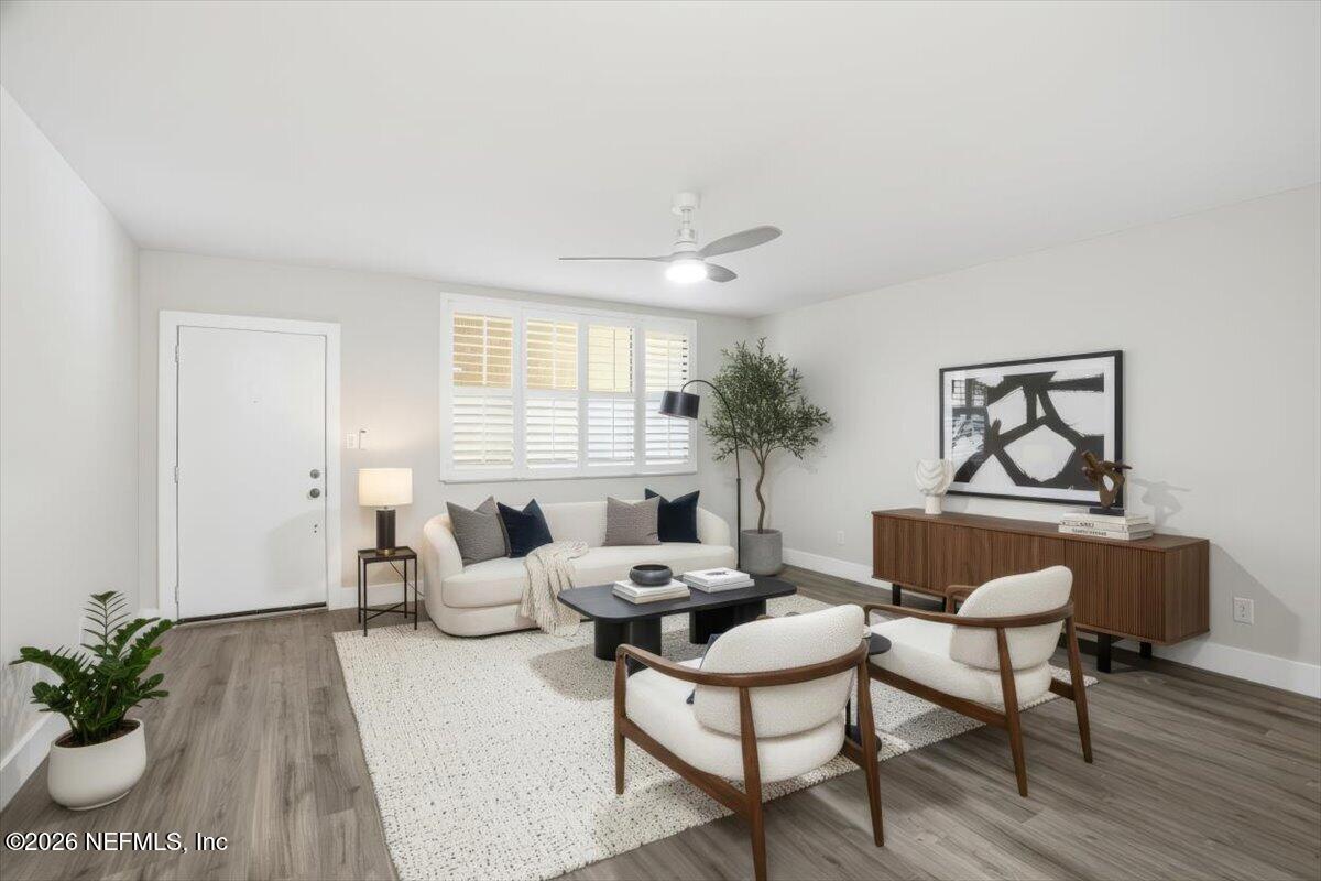 1810 Sevilla Boulevard West, Unit 310 Atlantic Beach, FL 32233 - Photo 3 of 18 a living room with furniture and a potted plant