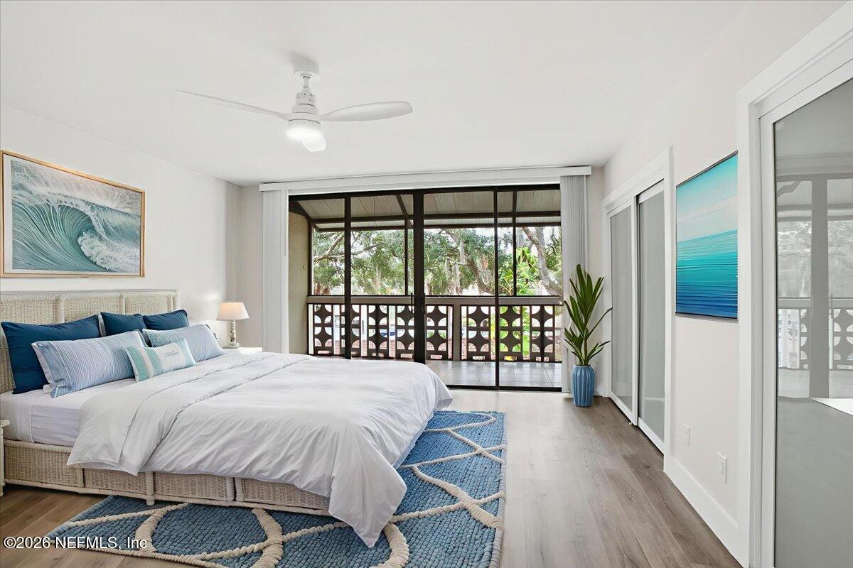 1810 Sevilla Boulevard West, Unit 310 Atlantic Beach, FL 32233 - Photo 9 of 18 a bedroom with a balcony a bed and a large window