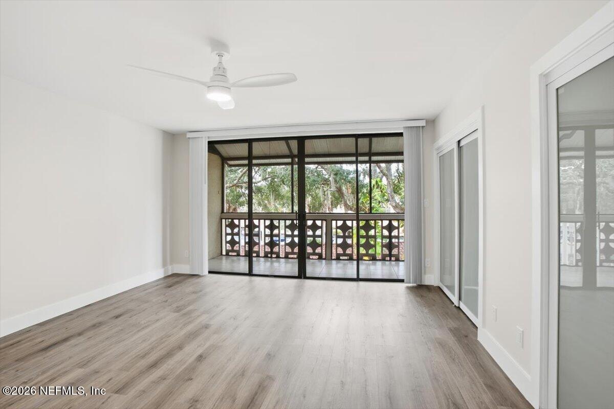 1810 Sevilla Boulevard West, Unit 310 Atlantic Beach, FL 32233 - Photo 10 of 18 wooden floor in an empty room with a window