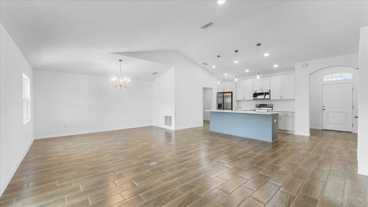1938 Jupiter Boulevard Southwest Palm Bay, FL 32908 - Photo 15 of 41 a view of kitchen with kitchen island white cabinets and wooden floor