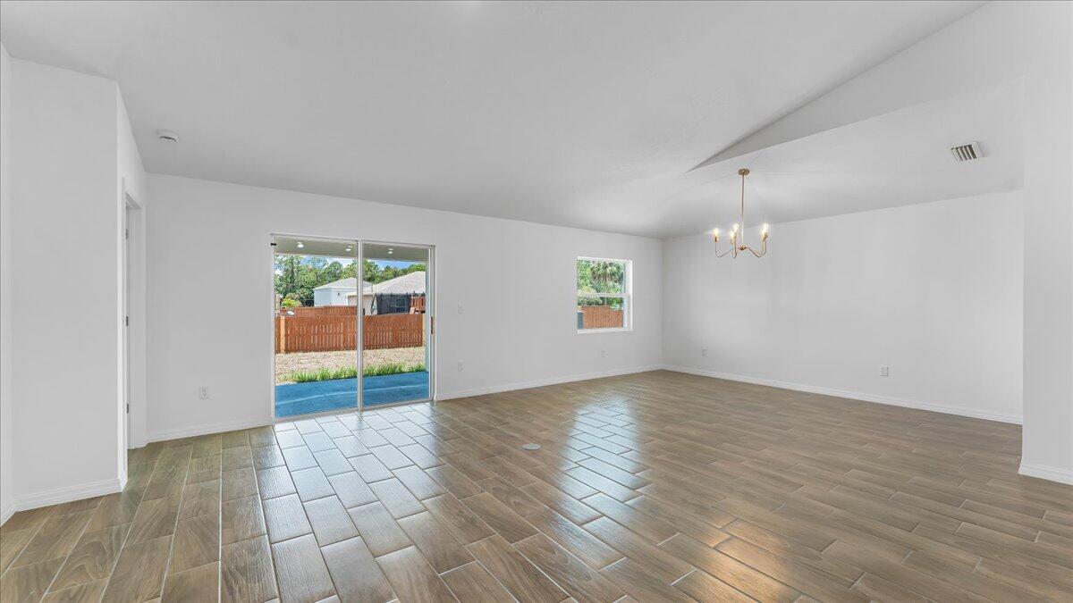 1938 Jupiter Boulevard Southwest Palm Bay, FL 32908 - Photo 16 of 41 an empty room with kitchen and windows