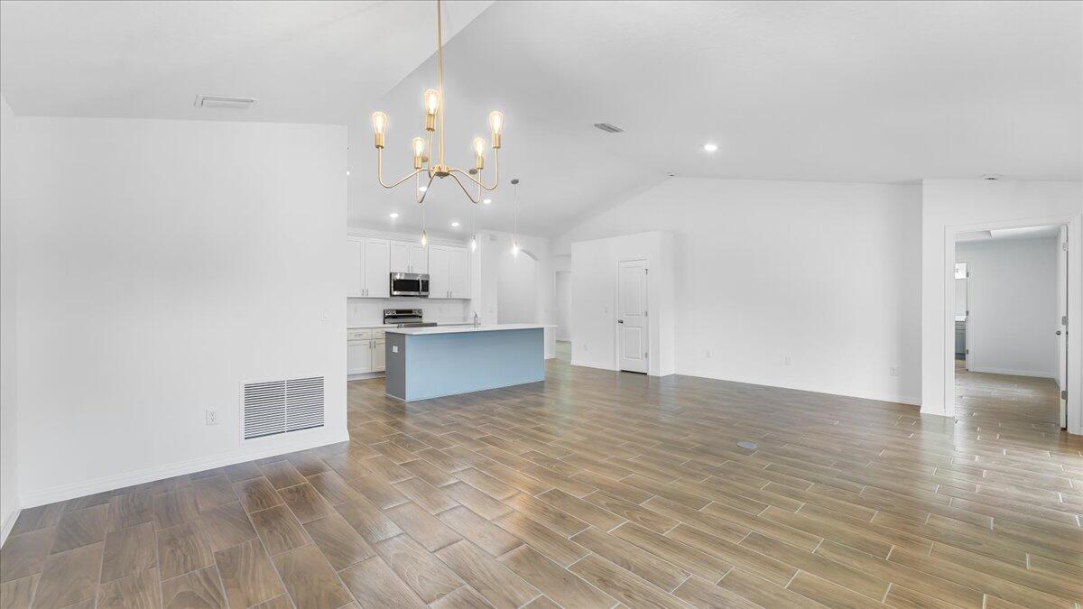 1938 Jupiter Boulevard Southwest Palm Bay, FL 32908 - Photo 18 of 41 a view of kitchen and hall with wooden floor
