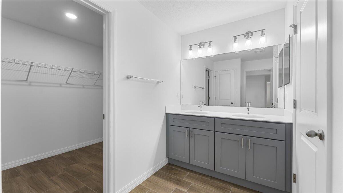 1938 Jupiter Boulevard Southwest Palm Bay, FL 32908 - Photo 20 of 41 a bathroom with a double vanity sink and a mirror