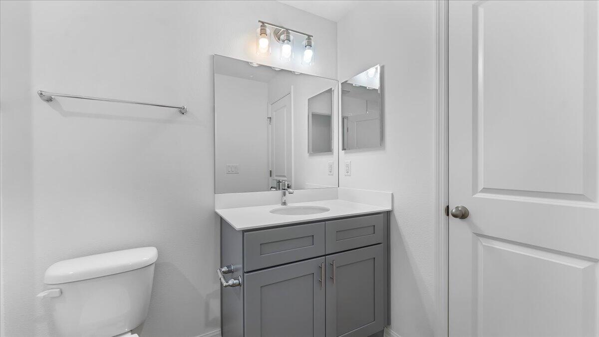 1938 Jupiter Boulevard Southwest Palm Bay, FL 32908 - Photo 24 of 41 a bathroom with a toilet a sink and mirror
