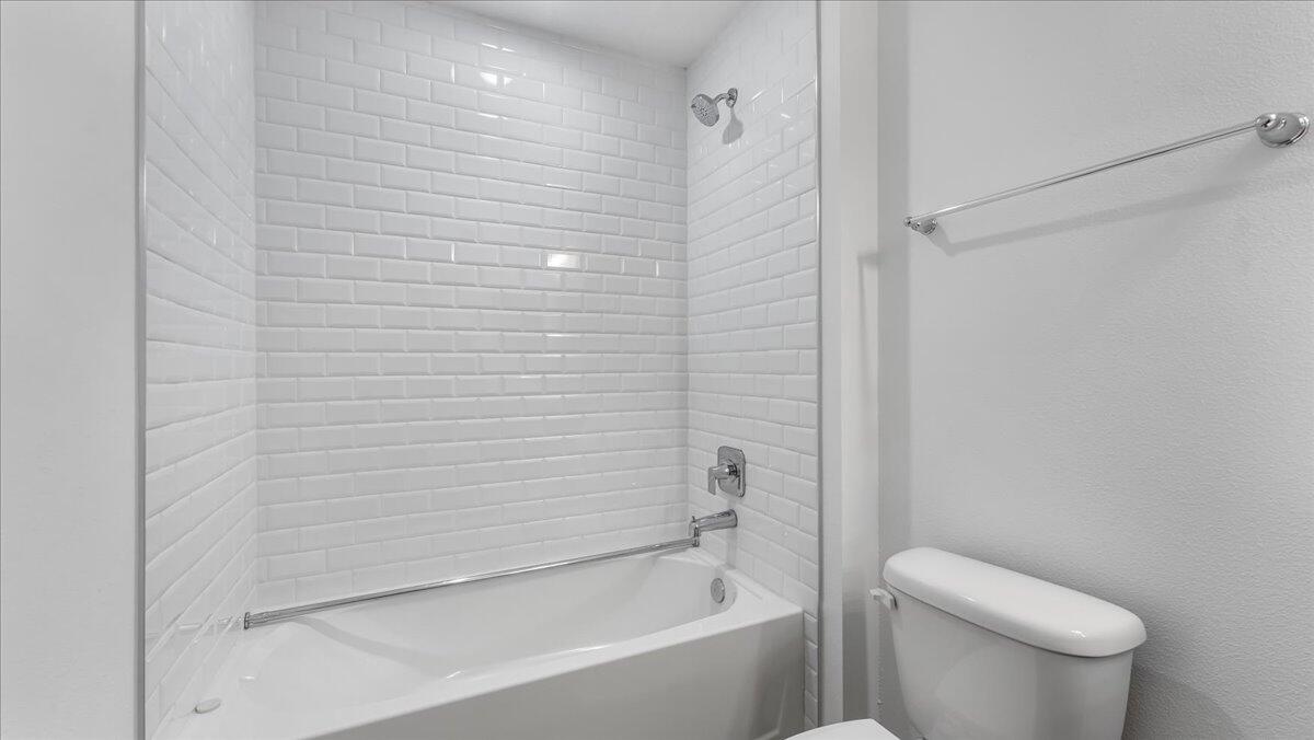 1938 Jupiter Boulevard Southwest Palm Bay, FL 32908 - Photo 25 of 41 a bathroom with a bathtub and a toilet