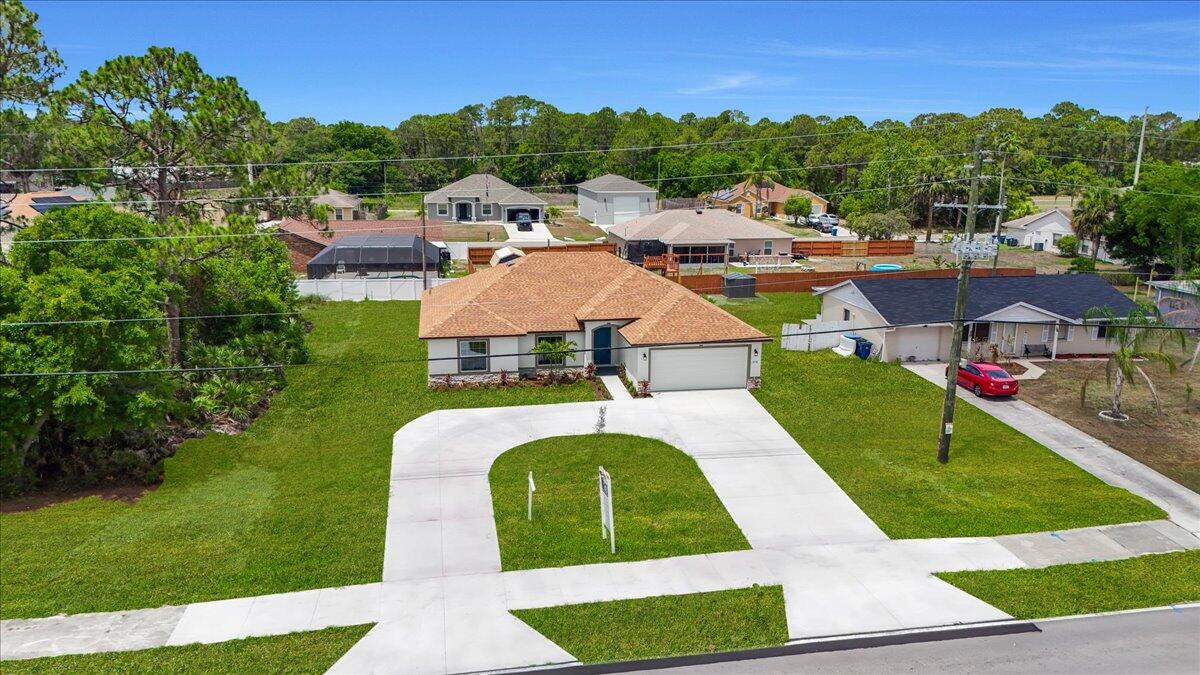 1938 Jupiter Boulevard Southwest Palm Bay, FL 32908 - Photo 32 of 41 a view of multiple houses with a big yard