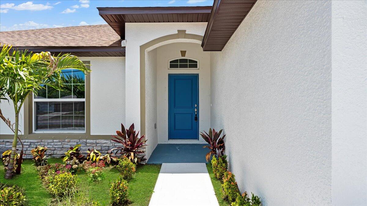 1938 Jupiter Boulevard Southwest Palm Bay, FL 32908 - Photo 6 of 41 a front view of a house with a yard