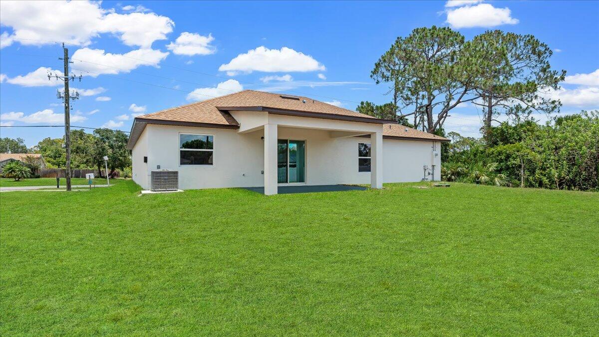 1938 Jupiter Boulevard Southwest Palm Bay, FL 32908 - Photo 8 of 41 a white house that has a tree in front of it