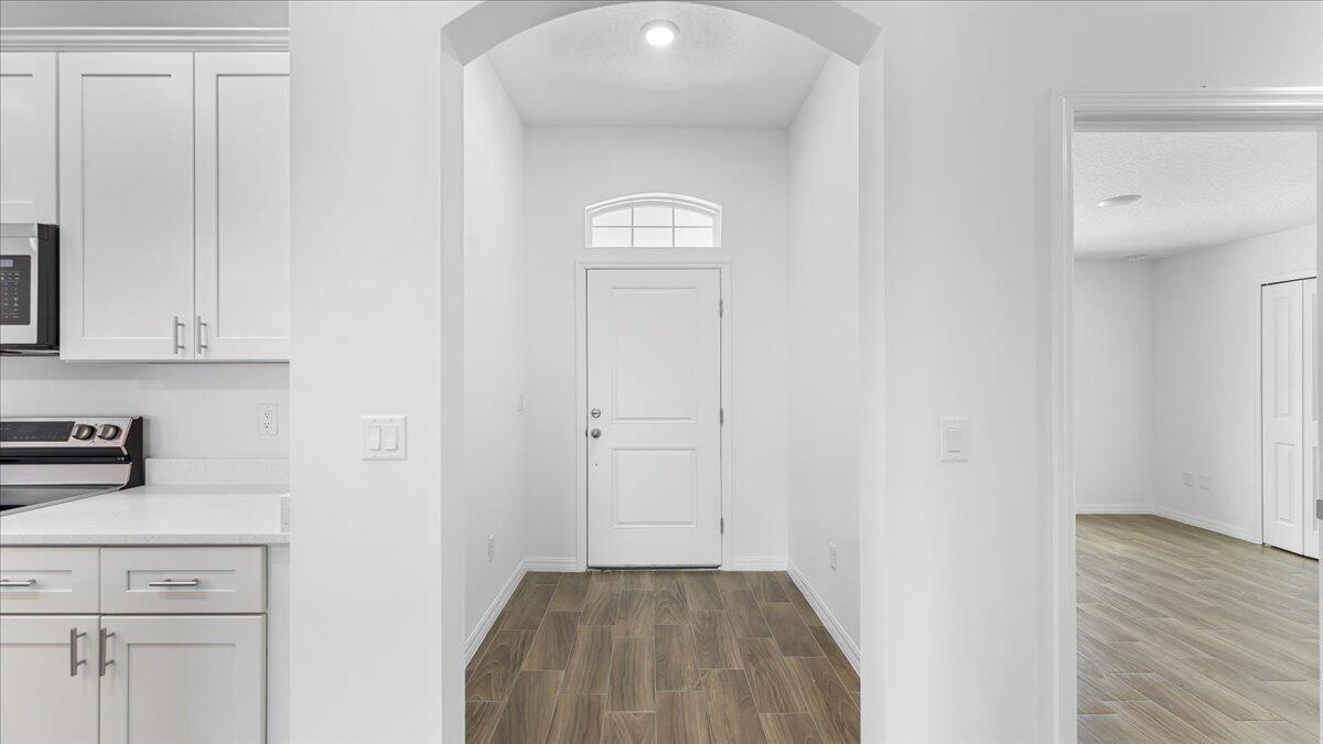 1938 Jupiter Boulevard Southwest Palm Bay, FL 32908 - Photo 9 of 41 a view of a hallway with wooden floor