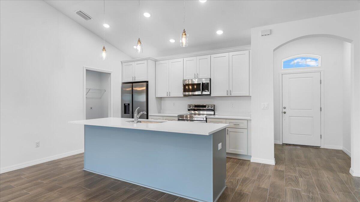 1938 Jupiter Boulevard Southwest Palm Bay, FL 32908 - Photo 10 of 41 a kitchen with kitchen island sink stove and cabinets