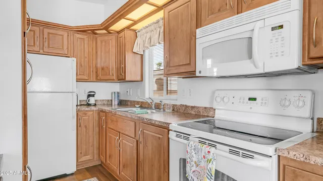 a kitchen with a sink a stove and a refrigerator
