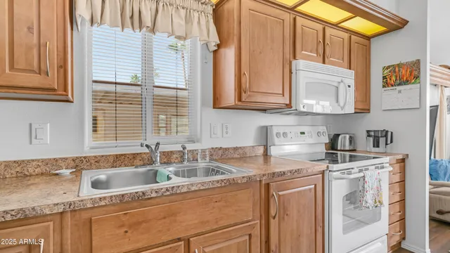 a kitchen with stainless steel appliances granite countertop a sink and a white cabinets