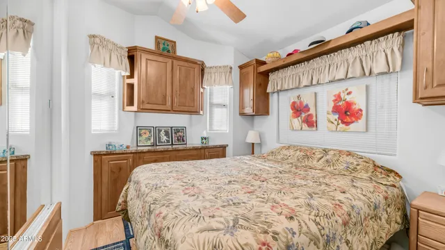 a bed sitting in a kitchen next to a window