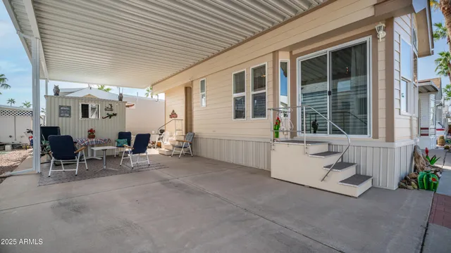 a view of a patio with table and chairs and potted plants