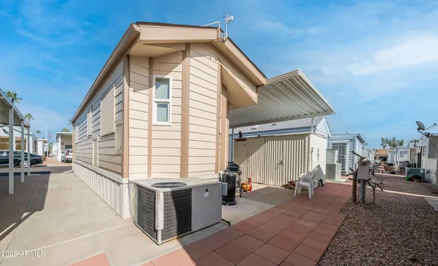 a view of a house with backyard and sitting area