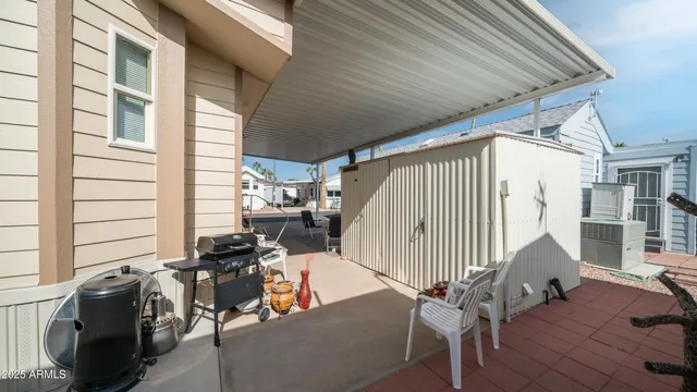 a view of a patio with table and chairs with wooden floor and fence