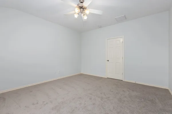 a view of an empty room with a fan