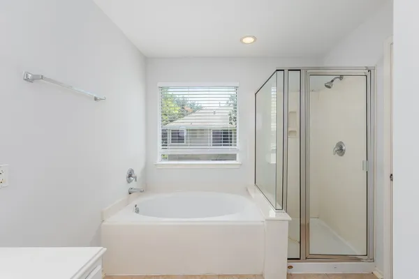 a white bath tub sitting next to a white sink