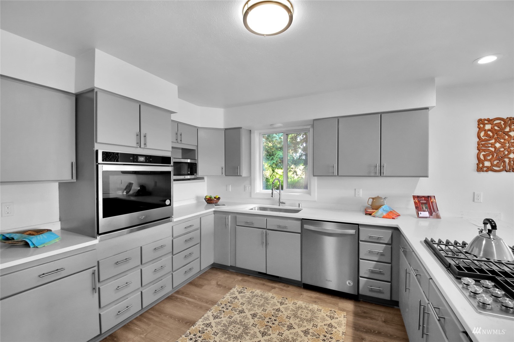4770 Lincoln Road Blaine, WA 98230 - Photo 22 of 36 a kitchen with stainless steel appliances a sink dishwasher a stove and cabinets