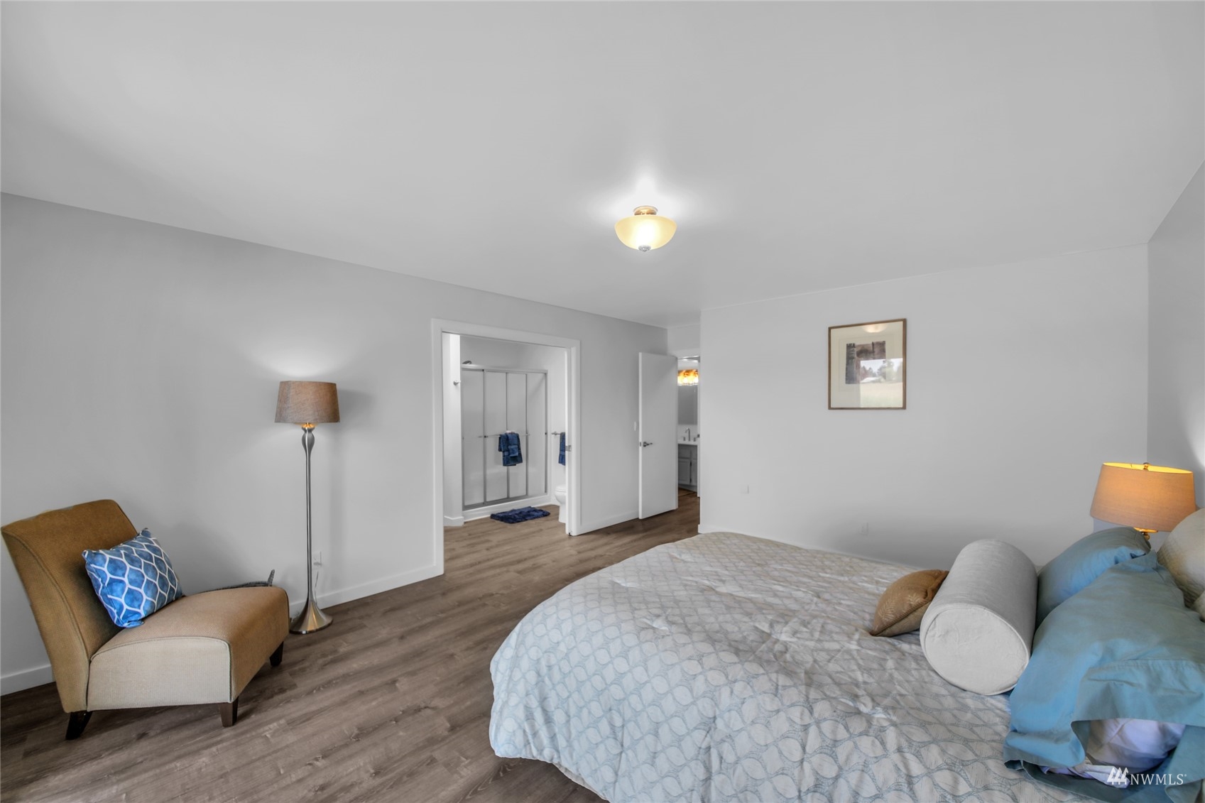 4770 Lincoln Road Blaine, WA 98230 - Photo 7 of 36 a spacious bedroom with a bed and a couch