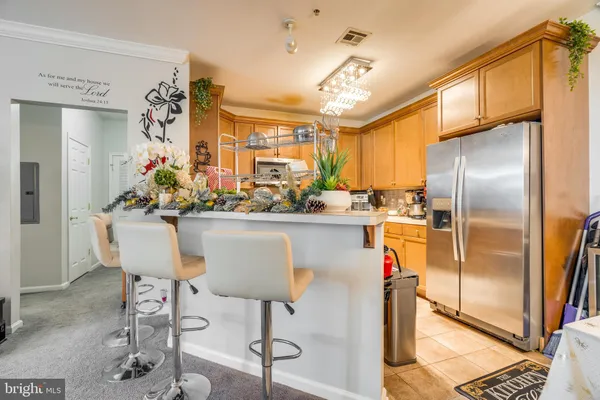 a kitchen with stainless steel appliances kitchen island granite countertop a refrigerator and a stove