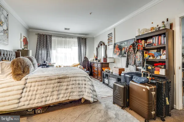 a bedroom with bed and a book shelf