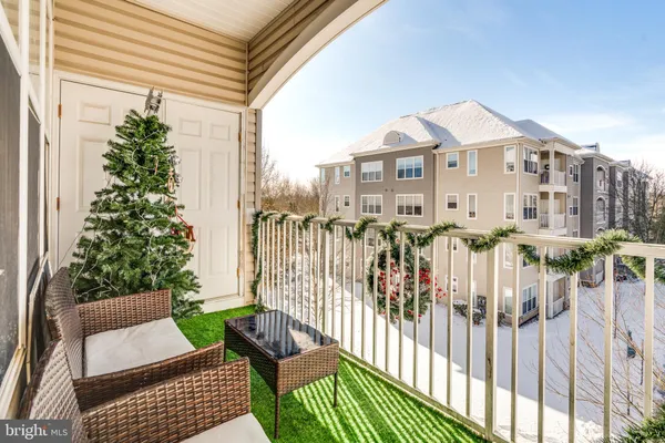 a view of a house with a small yard and furniture