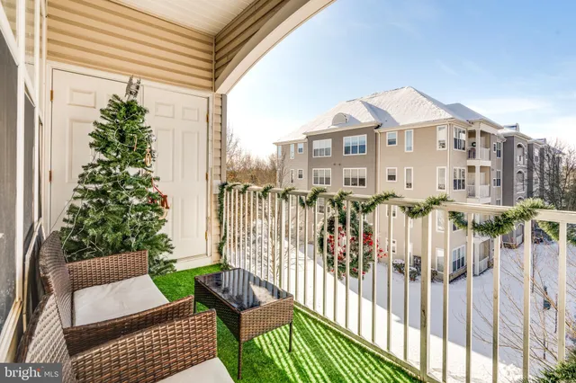 a view of a house with a small yard and furniture
