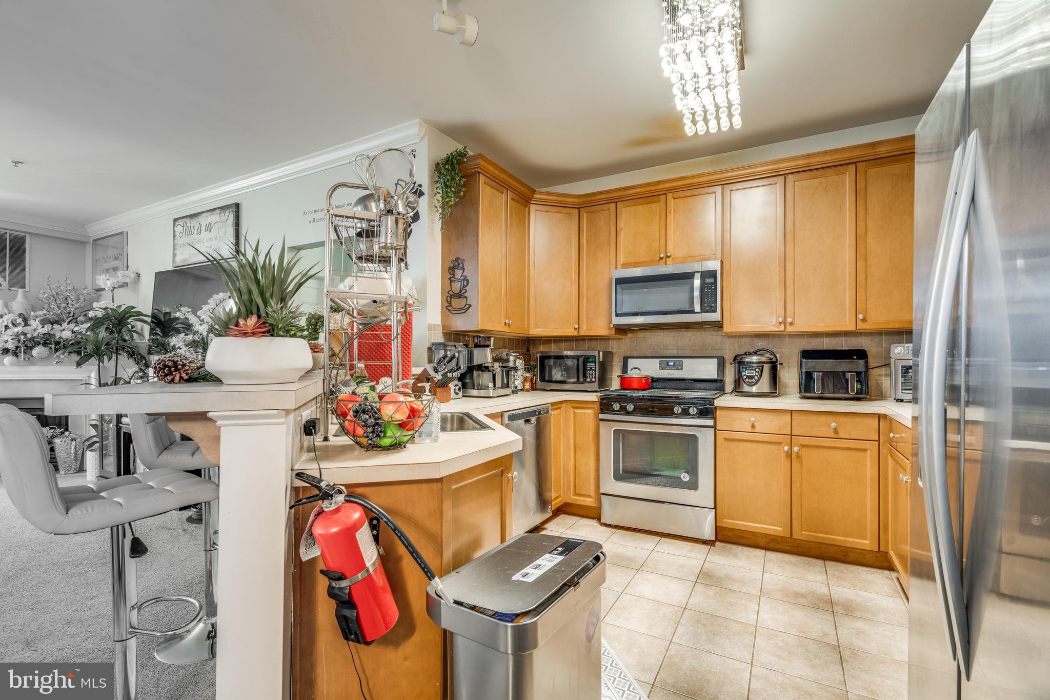 235 Masterson Court Ewing, NJ 08618 - Photo 4 of 19 a kitchen with stainless steel appliances kitchen island granite countertop a sink and cabinets