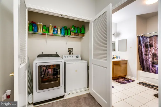 a utility room with fridge dryer and washer