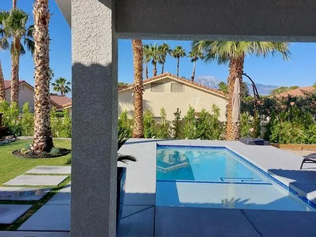 a kitchen with granite countertop white cabinets white stainless steel appliances with a sink and dishwasher
