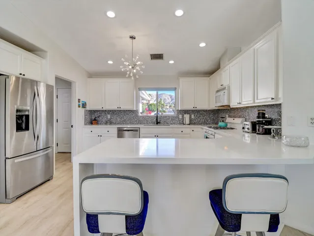 a spacious bedroom with a bed and a television