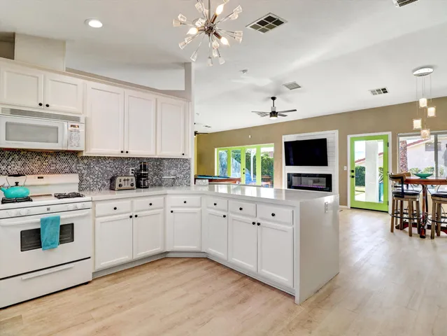a view of a hallway with painting on the wall