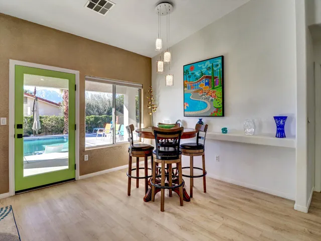 a living room with furniture flat screen tv and a large window